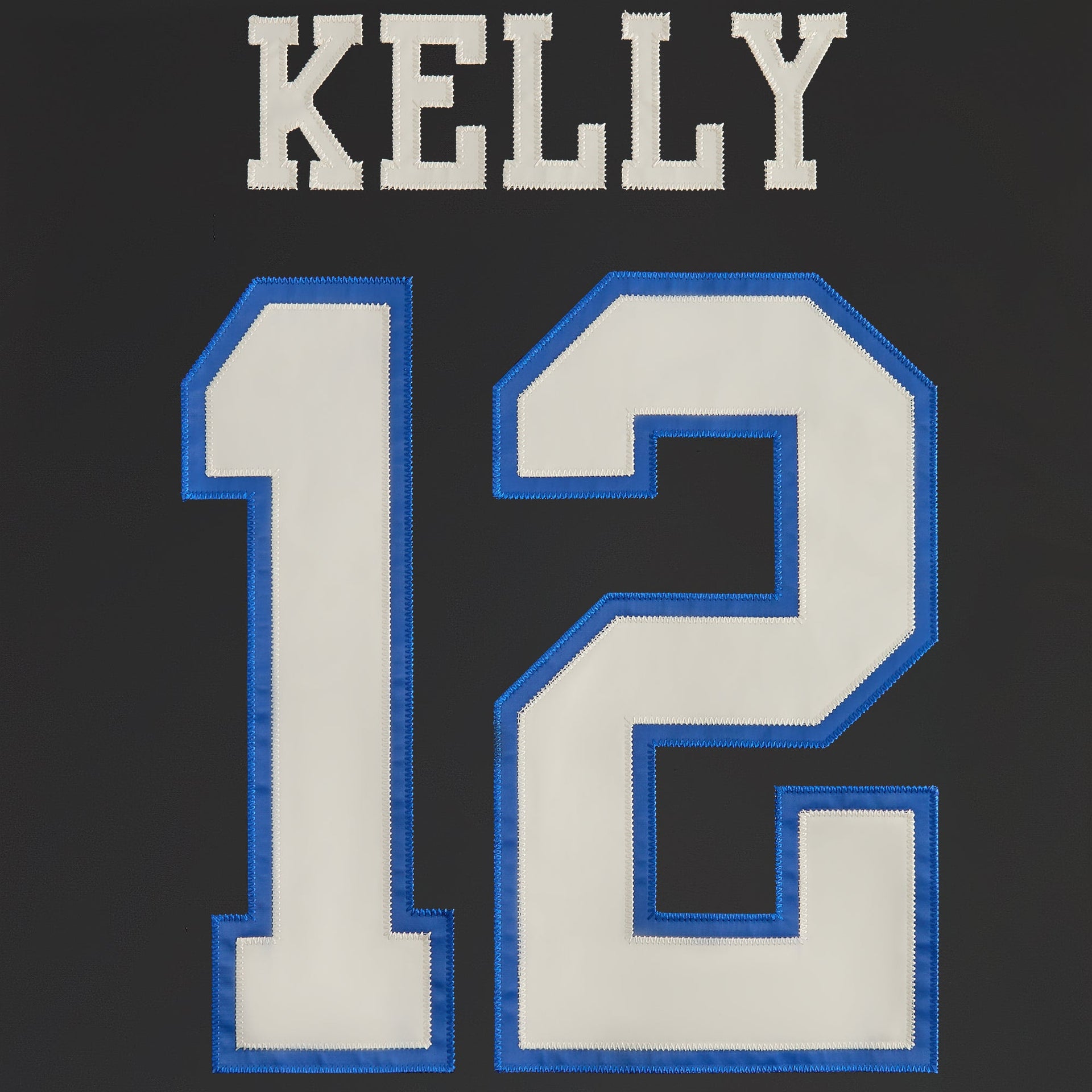 Patch with 'KELLY' and number '12' on a dark background